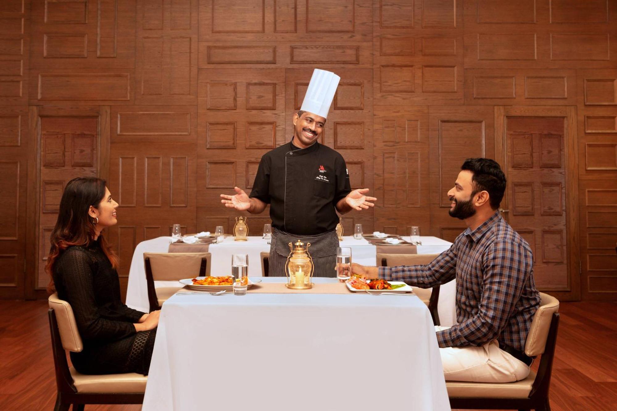 Kochi Marriott Hotel Екстер'єр фото A chef serving food to guests